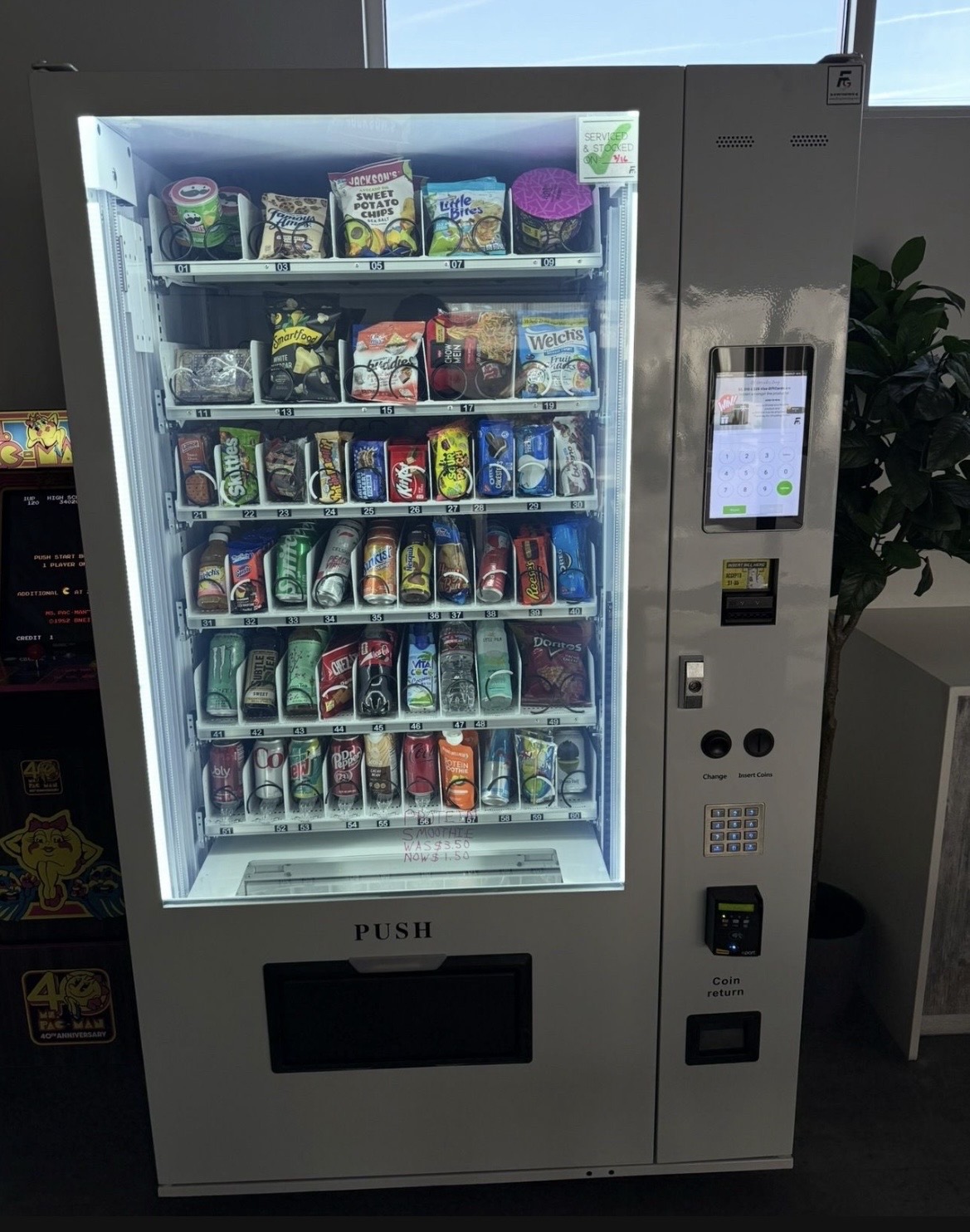 Touchscreen snack and drink combo vending machine in a modern lounge